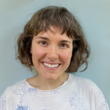 Landry smiles at the camera for her headshot. She has short brown hair with bangs and brown eyes.